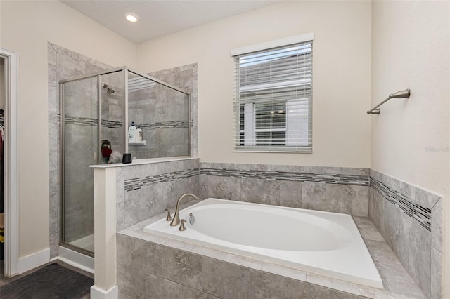 bathroom featuring independent shower and bath