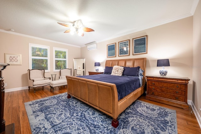 bedroom featuring crown molding, ceiling fan, a wall mounted air conditioner, and hardwood / wood-style flooring