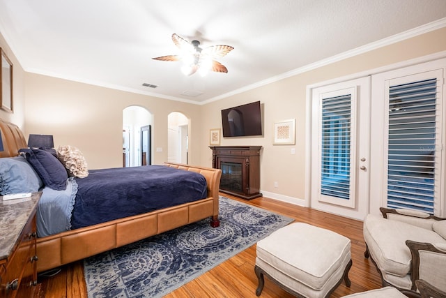 bedroom with crown molding, ceiling fan, and hardwood / wood-style floors