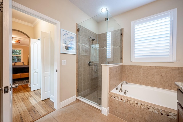 bathroom featuring vanity, tile patterned floors, ornamental molding, and shower with separate bathtub