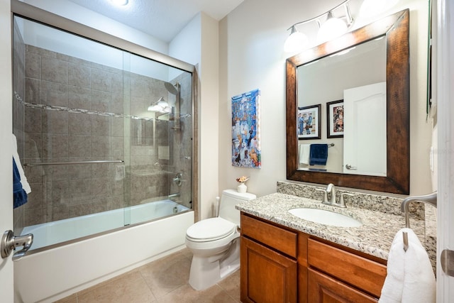 full bathroom featuring vanity, tile patterned floors, toilet, and combined bath / shower with glass door