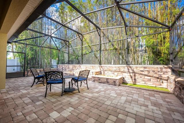 view of patio / terrace featuring a lanai