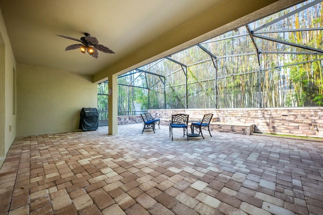 view of patio / terrace with a lanai, area for grilling, and ceiling fan