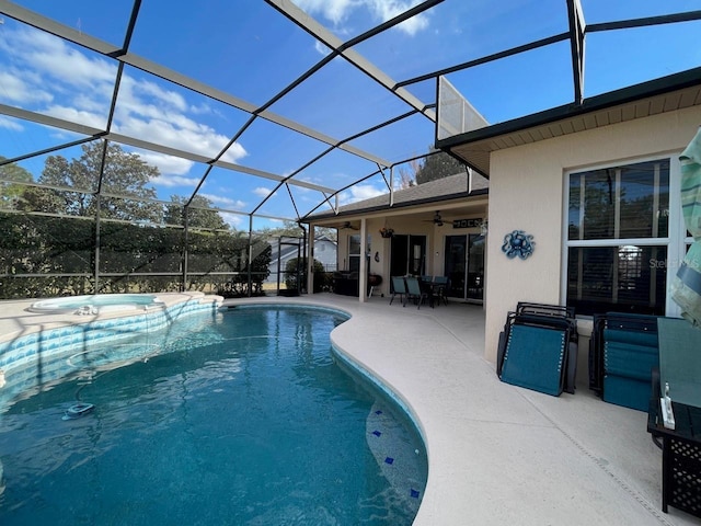 view of pool featuring a patio, an in ground hot tub, ceiling fan, and glass enclosure