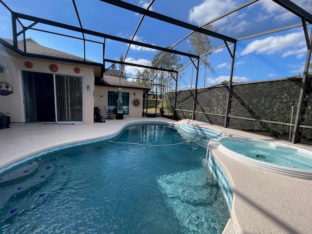 view of pool with an in ground hot tub, a lanai, and a patio area