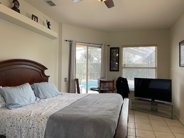 tiled bedroom featuring multiple windows, access to outside, and ceiling fan