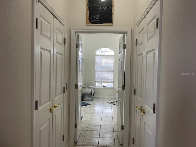 corridor with light tile patterned flooring