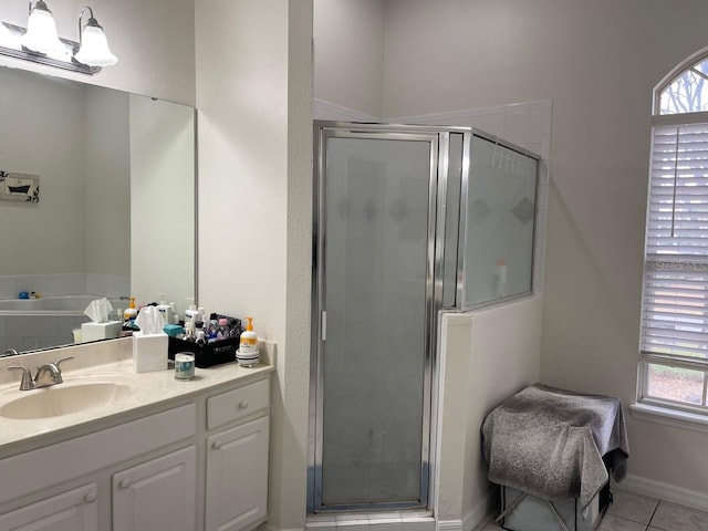 bathroom featuring tile patterned flooring, vanity, and a shower with shower door