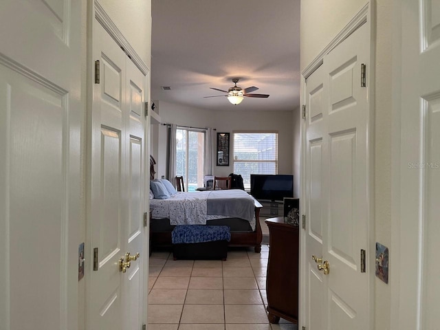 bedroom featuring light tile patterned flooring and ceiling fan