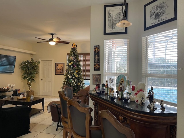 dining space featuring light tile patterned floors and ceiling fan