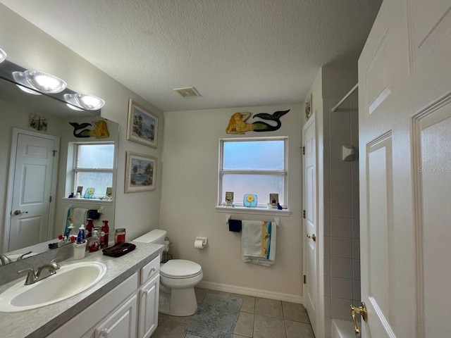 full bathroom featuring vanity, a textured ceiling, bathtub / shower combination, tile patterned floors, and toilet