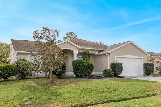 view of front facade featuring a front lawn, an attached garage, driveway, and stucco siding