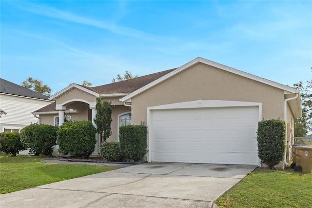 ranch-style house with a front lawn, an attached garage, concrete driveway, and stucco siding