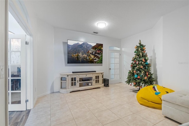 tiled living room with a textured ceiling