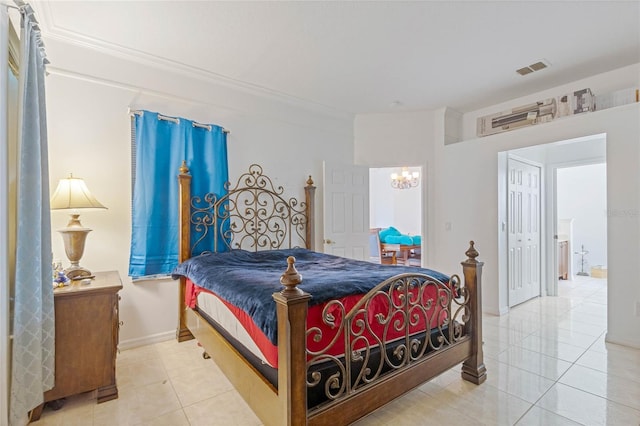 bedroom featuring an inviting chandelier, a closet, and tile patterned floors