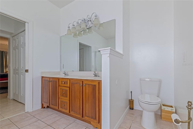 bathroom with tile patterned floors, vanity, and toilet