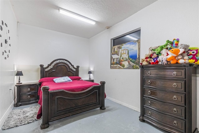 bedroom with concrete flooring and a textured ceiling