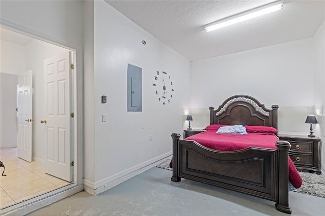 bedroom with electric panel and a textured ceiling