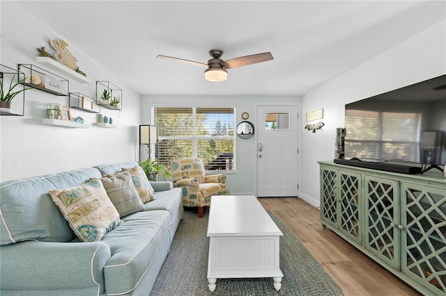 living room featuring ceiling fan and light hardwood / wood-style floors