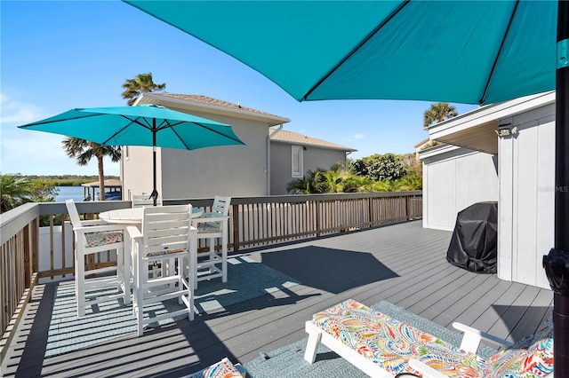 wooden deck featuring a water view