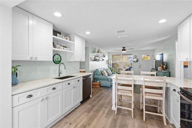 kitchen with sink, white cabinetry, dishwasher, ceiling fan, and light hardwood / wood-style floors