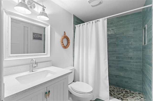 bathroom with walk in shower, vanity, and toilet