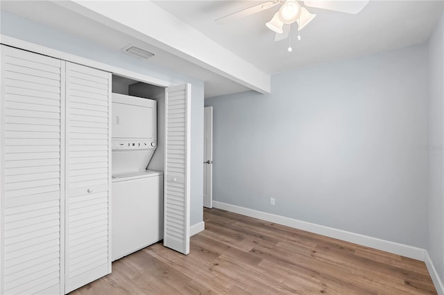 clothes washing area with stacked washer / drying machine, ceiling fan, and light wood-type flooring