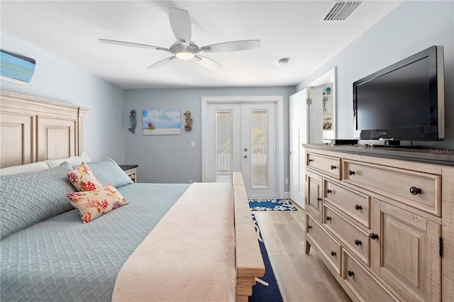 bedroom with access to outside, french doors, ceiling fan, and light wood-type flooring