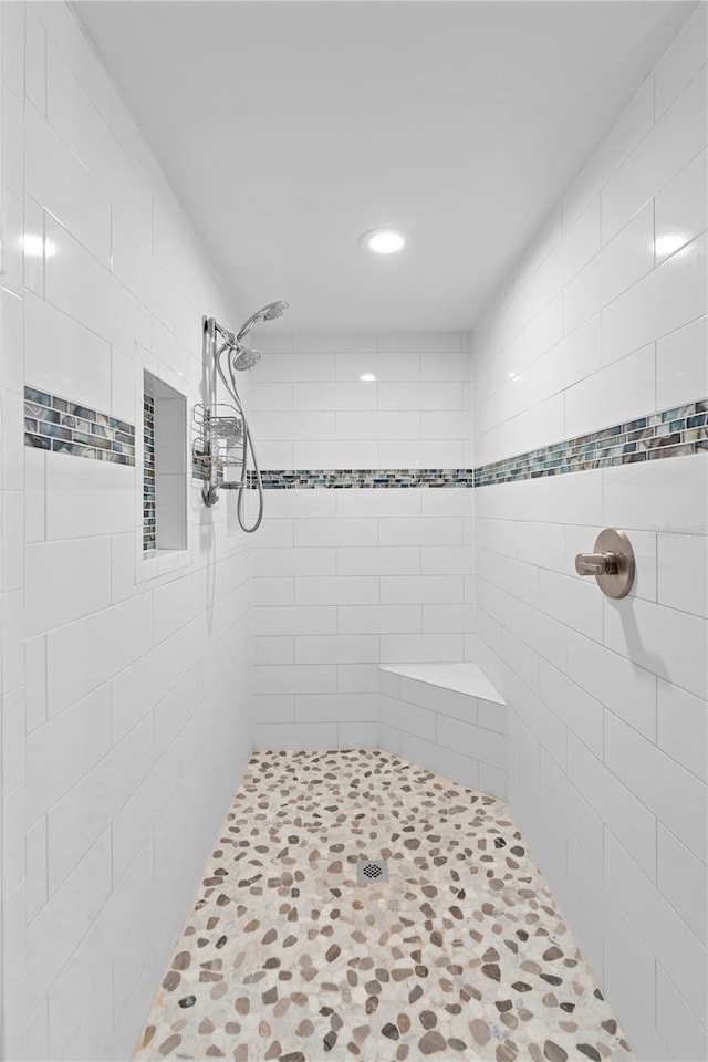 bathroom with a tile shower