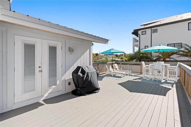 wooden deck with a grill