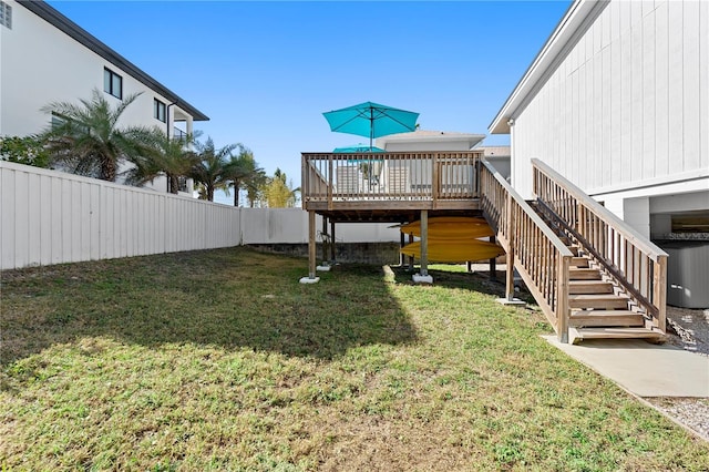 view of yard featuring central AC unit and a deck