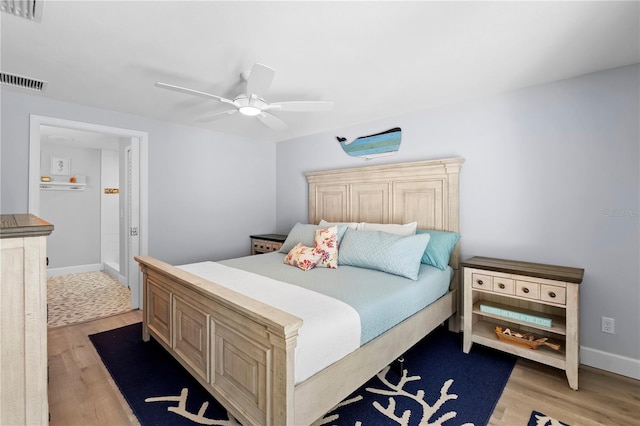 bedroom with ceiling fan and light hardwood / wood-style floors