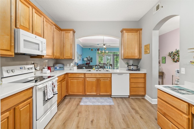 kitchen featuring white appliances, a textured ceiling, sink, light wood-type flooring, and ceiling fan