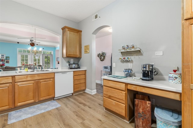 kitchen with sink, dishwasher, ceiling fan, and light hardwood / wood-style floors