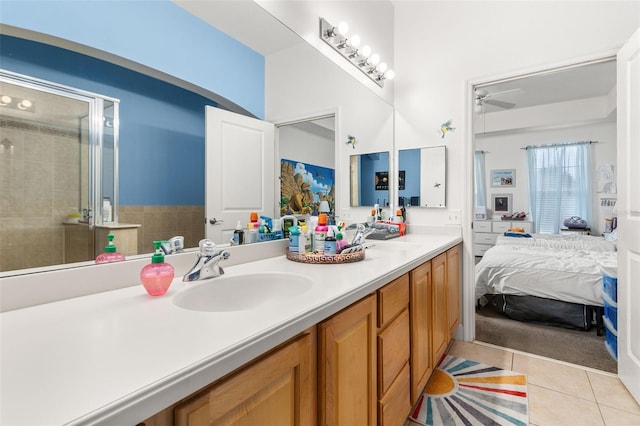 bathroom with ceiling fan, tile patterned floors, vanity, and a shower with shower door