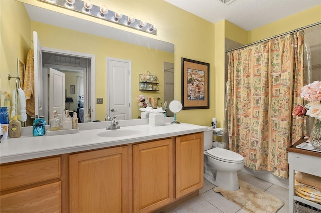 bathroom with toilet, a textured ceiling, walk in shower, tile patterned flooring, and vanity