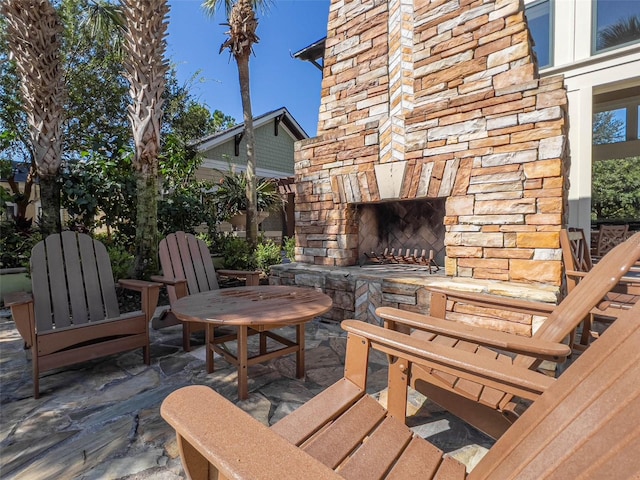 view of patio featuring an outdoor stone fireplace