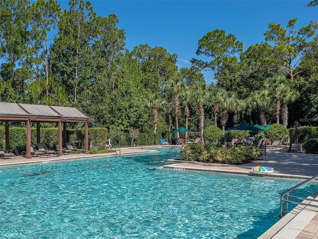 view of swimming pool featuring a patio area and a gazebo