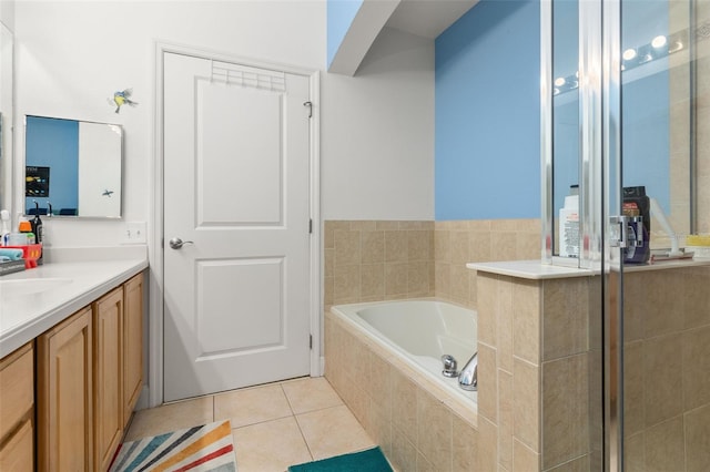 bathroom featuring vanity, a shower stall, tile patterned flooring, and a garden tub