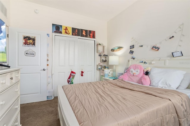 bedroom with a closet and dark carpet