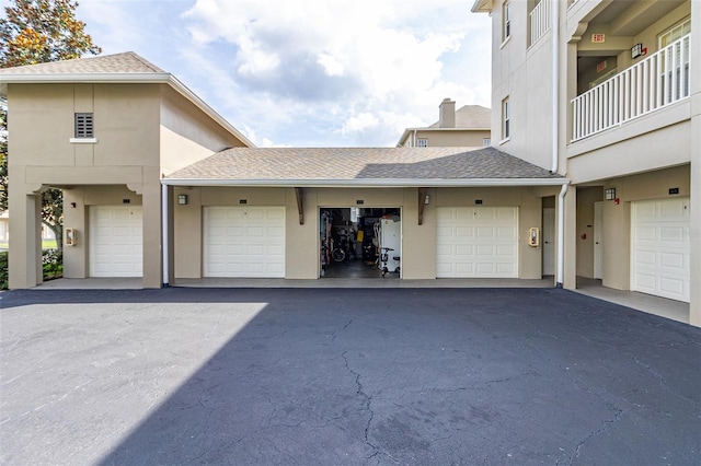 view of front of home featuring a shingled roof and stucco siding