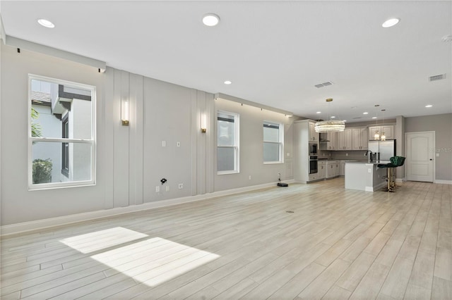 unfurnished living room with light hardwood / wood-style floors