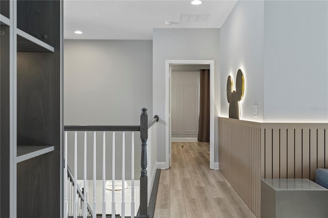 corridor with light hardwood / wood-style flooring