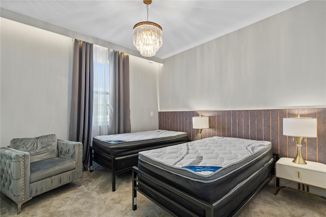 bedroom with an inviting chandelier and light colored carpet