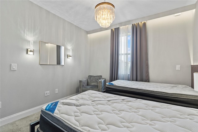 bedroom with an inviting chandelier and carpet floors