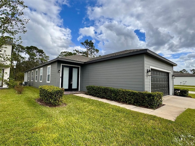 ranch-style home with a front lawn and a garage