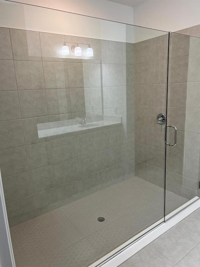 bathroom with walk in shower and tile patterned floors