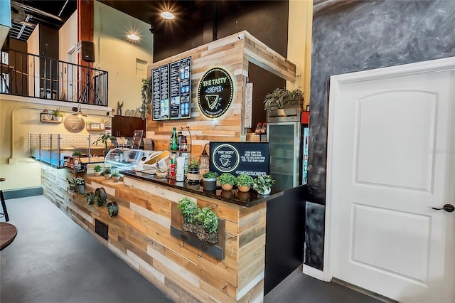 interior space featuring wooden walls and concrete flooring