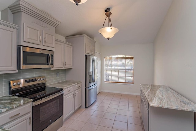 kitchen with white cabinets, stainless steel appliances, light tile patterned floors, and decorative backsplash