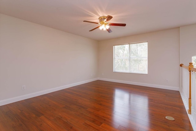 unfurnished room with ceiling fan and dark hardwood / wood-style flooring